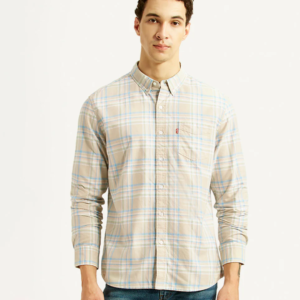“Man wearing Levi’s beige plaid check shirt with blue jeans on plain background”